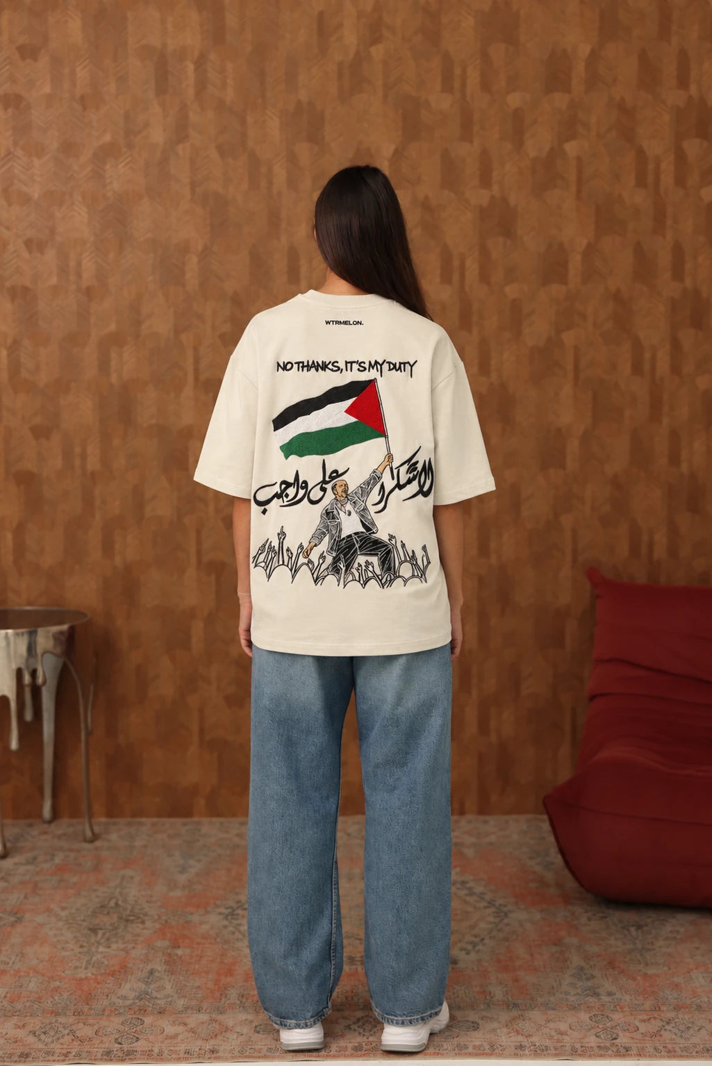 The Voice Off White T shirt on female model, back view with black embroidered lettering and hands, AI edited colourway visualization