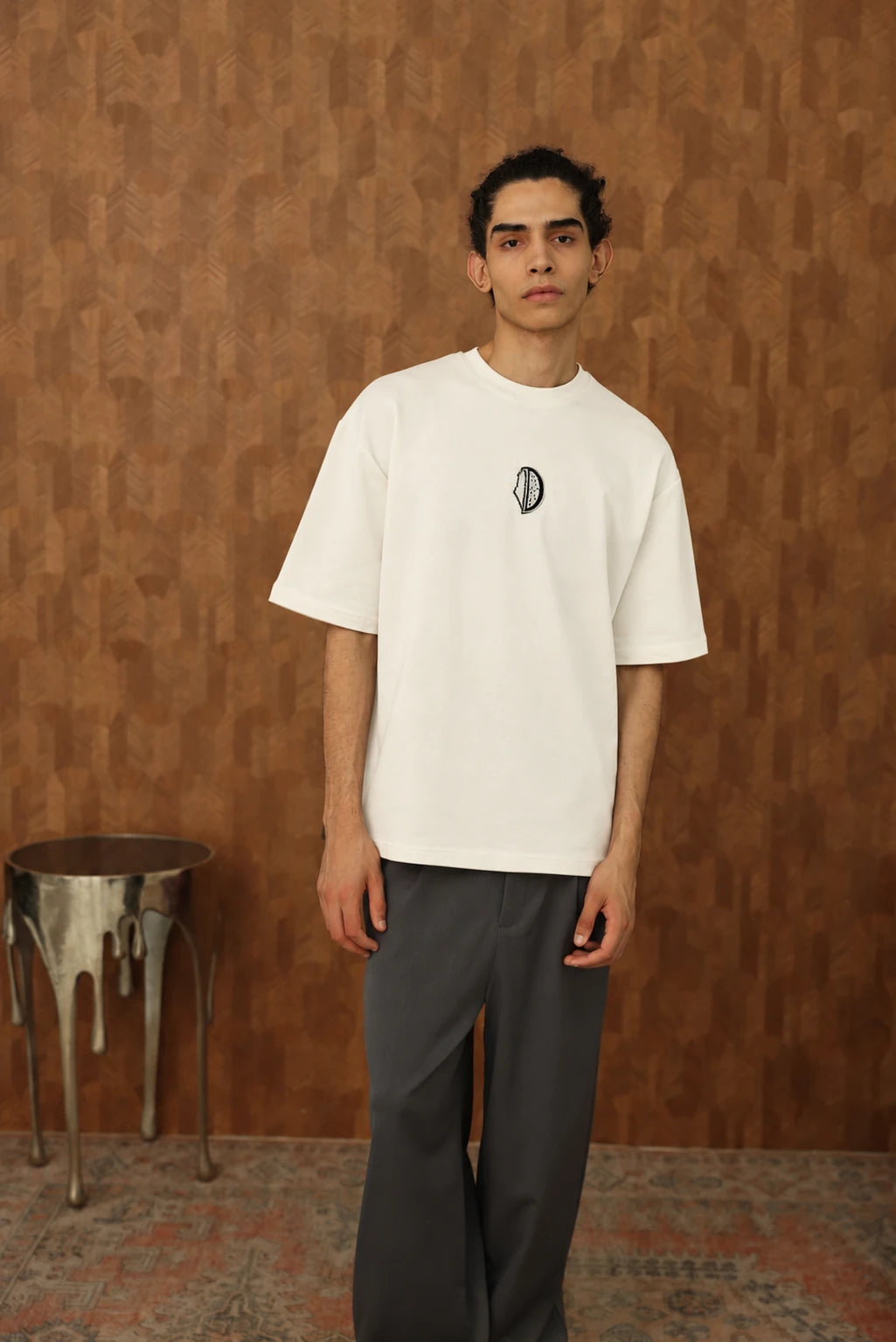 The Voice Off White T shirt on male model, front view with black chest embroidery, AI edited colourway visualization